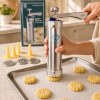 Prensa para galletas Grünberg con accesorios Prensa manual para galletas Grünberg con discos, boquillas y galletas de diferentes formas.