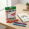 Caja y rotuladores Alpino Double junto a un cuaderno