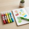 Rotuladores Maped Color’Peps XXL junto a un cuaderno con dibujos