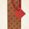 Bolsa de regalo para botella roja y verde con estampado geométrico dorado