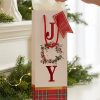 Bolsa de regalo JOY con papel de seda en una escena navideña