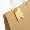 Bolsa de regalo kraft con lunares dorados, detalle del estampado y las asas