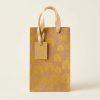 Bolsa de regalo kraft con arcoíris amarillos y asas doradas, vista frontal