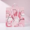 Bolsa geométrica rosa de regalo sobre fondo rosa suave