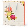 Bolsa de regalo floral con borde ondulado dorado y lateral rosa — vista frontal
