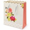 Bolsa de regalo floral con borde ondulado dorado y lateral rosa — vista lateral